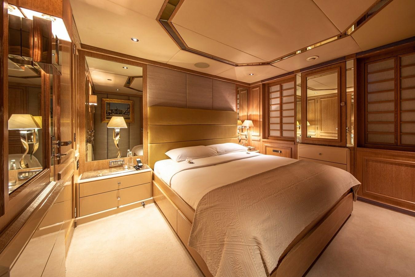 a room with a bed and a mirror aboard VA BENE Yacht for Sale