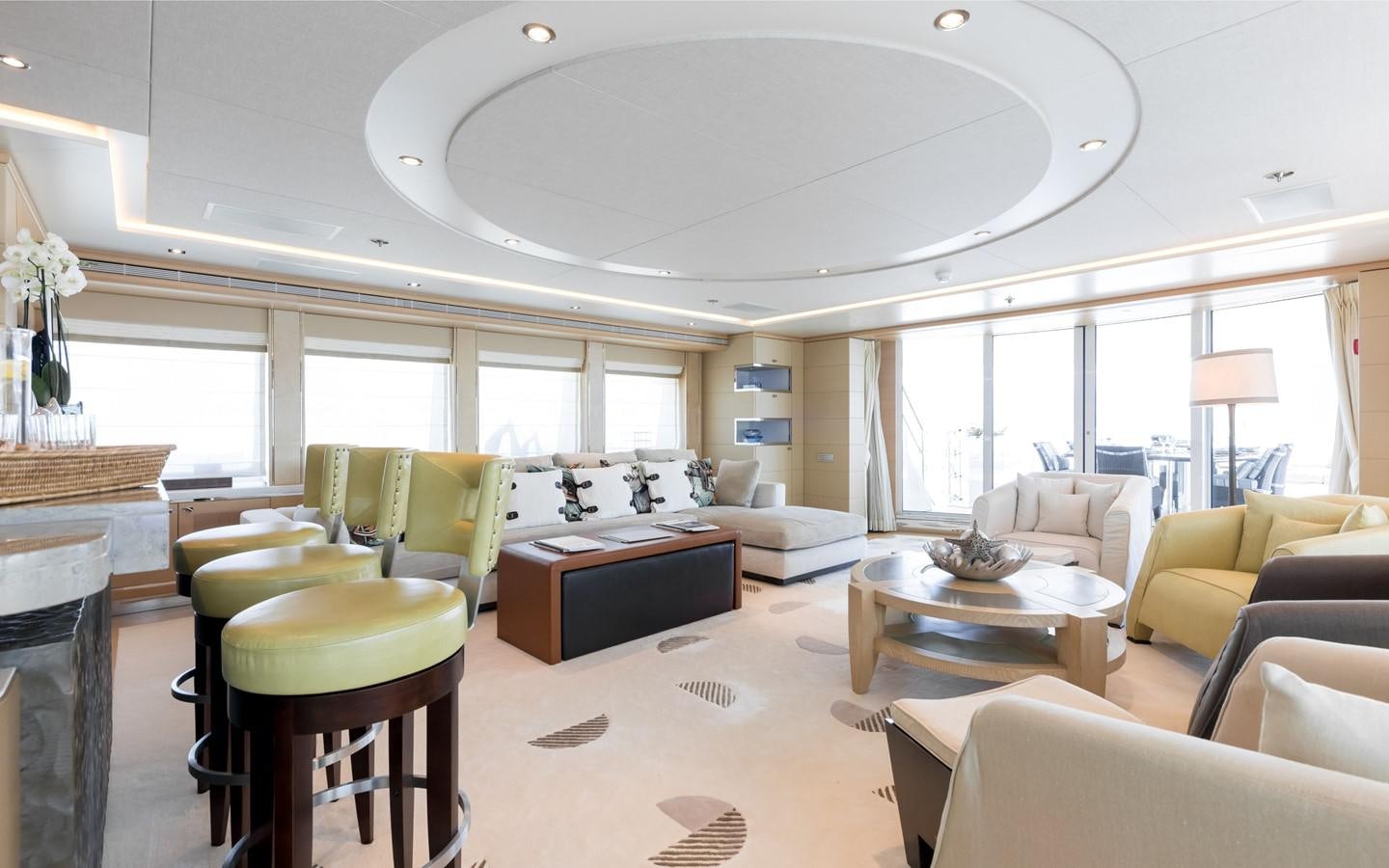 a large living room with a large window aboard ATINA Yacht for Sale