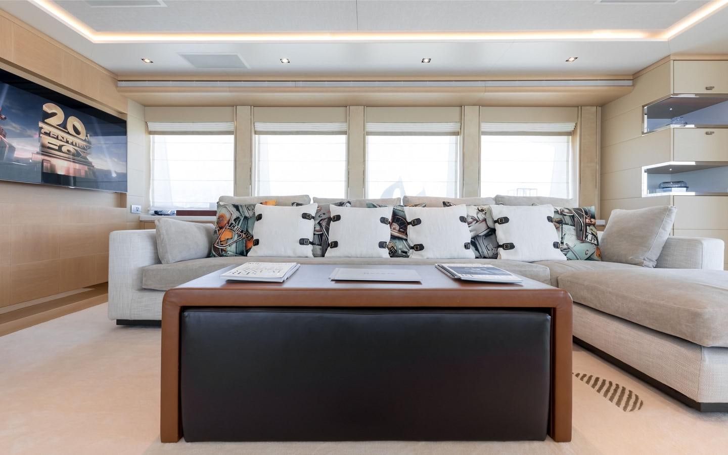 a living room with a couch and a table aboard ATINA Yacht for Sale