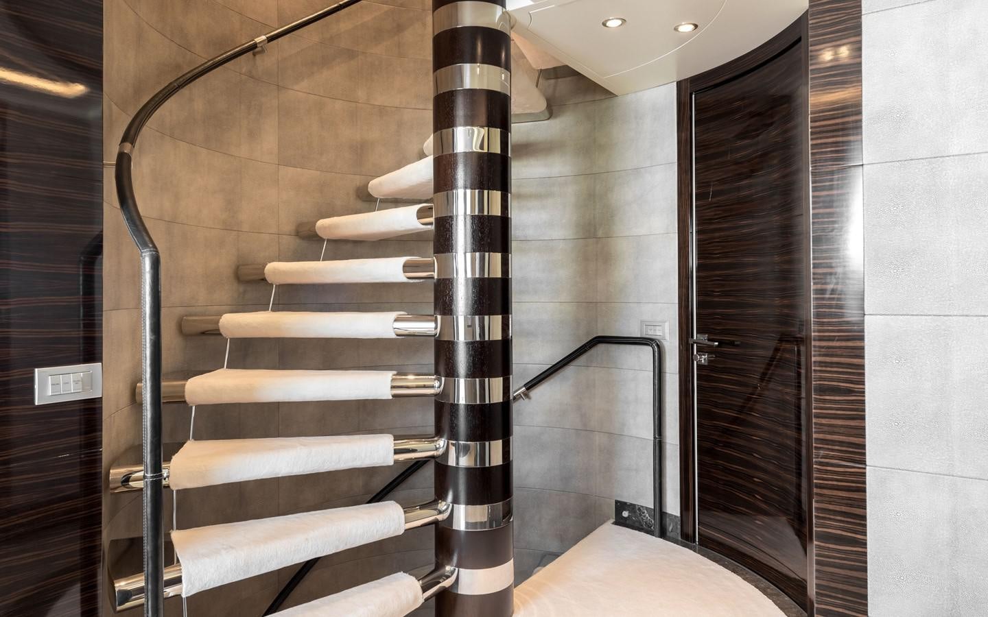 a staircase with a glass railing aboard ATINA Yacht for Sale