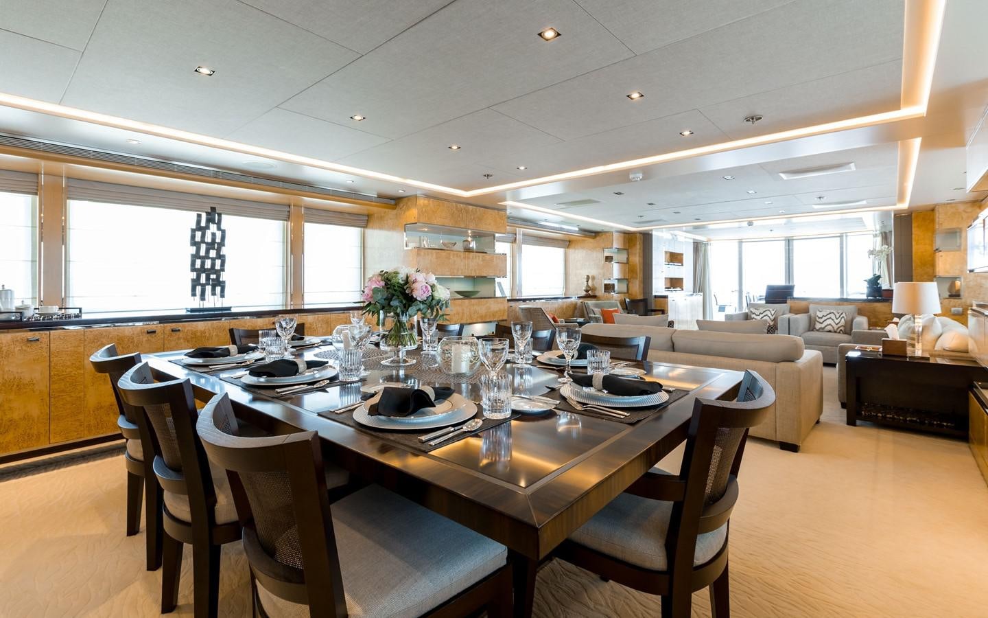 a large dining table with chairs aboard ATINA Yacht for Sale