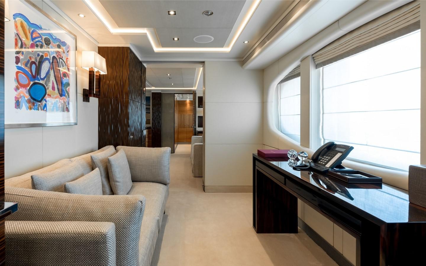 a living room with a couch and a desk aboard ATINA Yacht for Sale