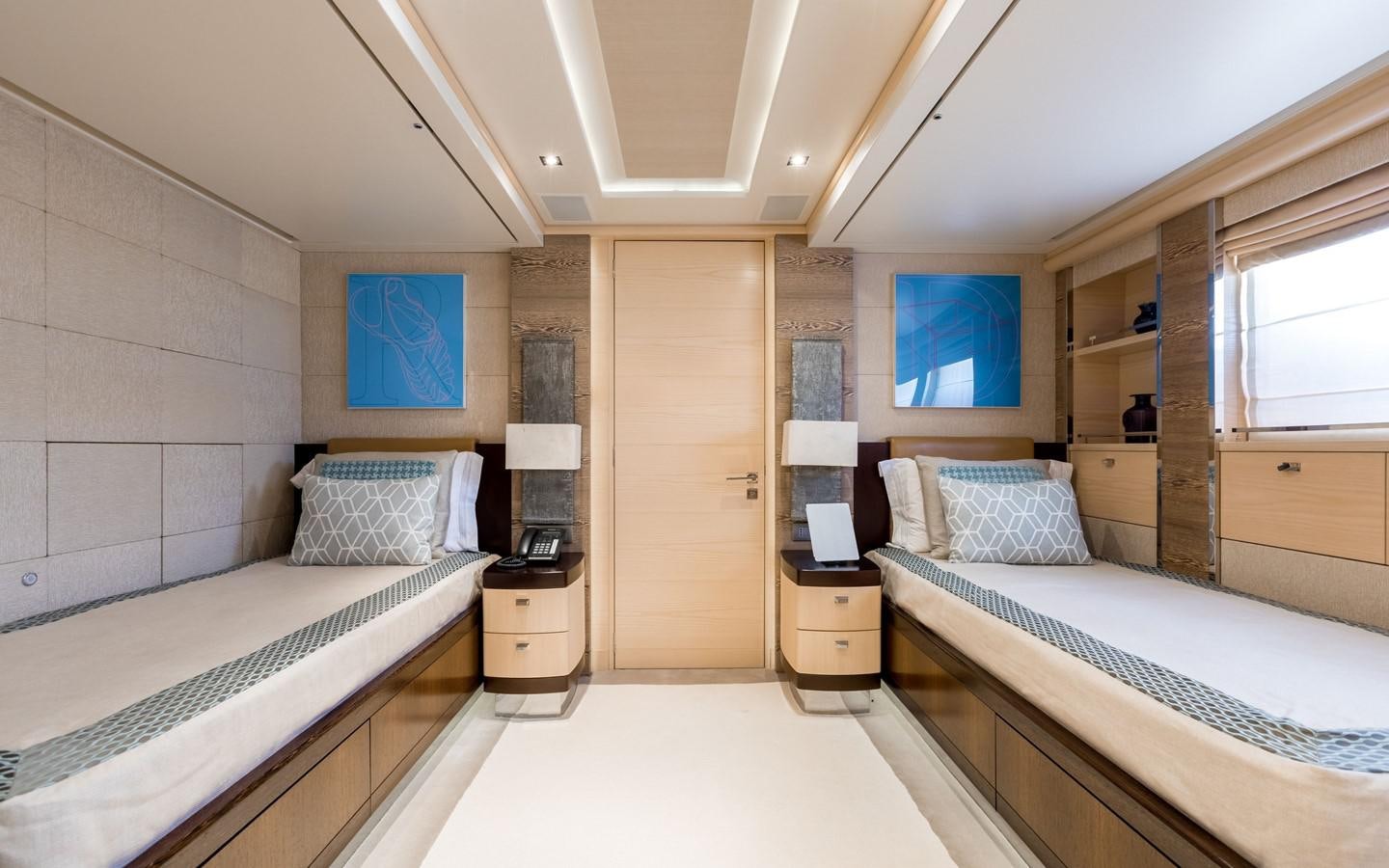 a room with two beds aboard ATINA Yacht for Sale
