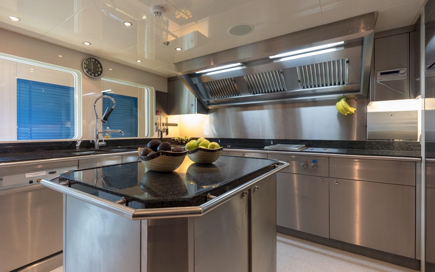 a kitchen with a steel stove aboard ATINA Yacht for Sale