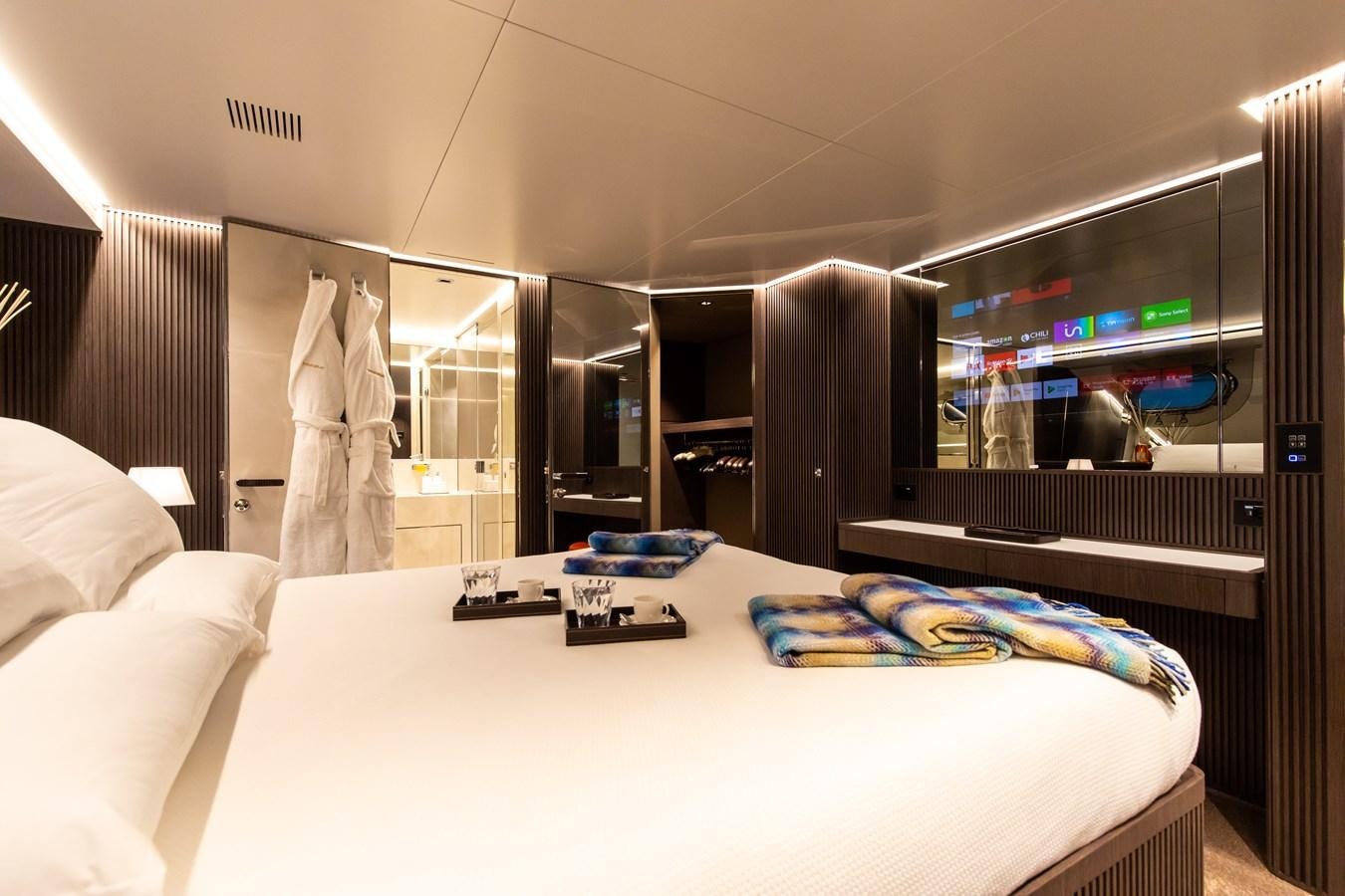 a hotel room with a bed and tv aboard CLOUD ATLAS Yacht for Charter
