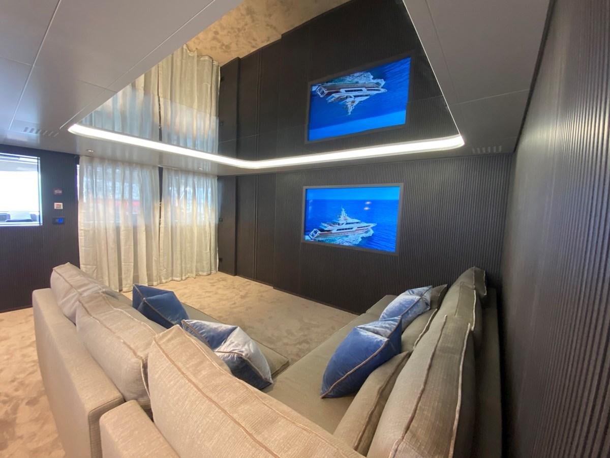 a room with a couch and a tv on the wall aboard CLOUD ATLAS Yacht for Charter