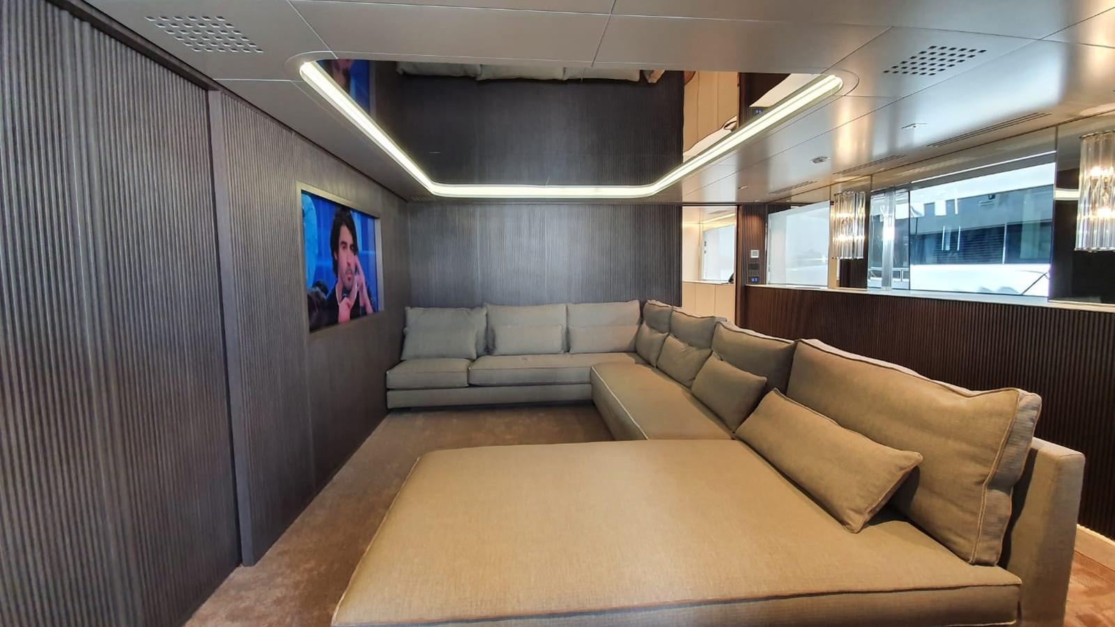 a living room with a large screen aboard CLOUD ATLAS Yacht for Charter