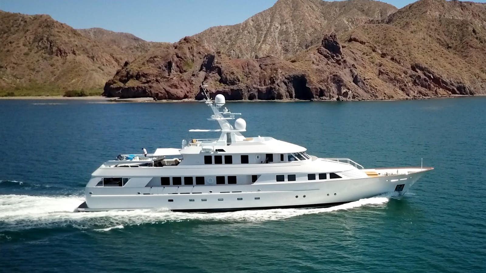 a white yacht in the water with Lake Mead in the background aboard SCORPIO Yacht for Sale
