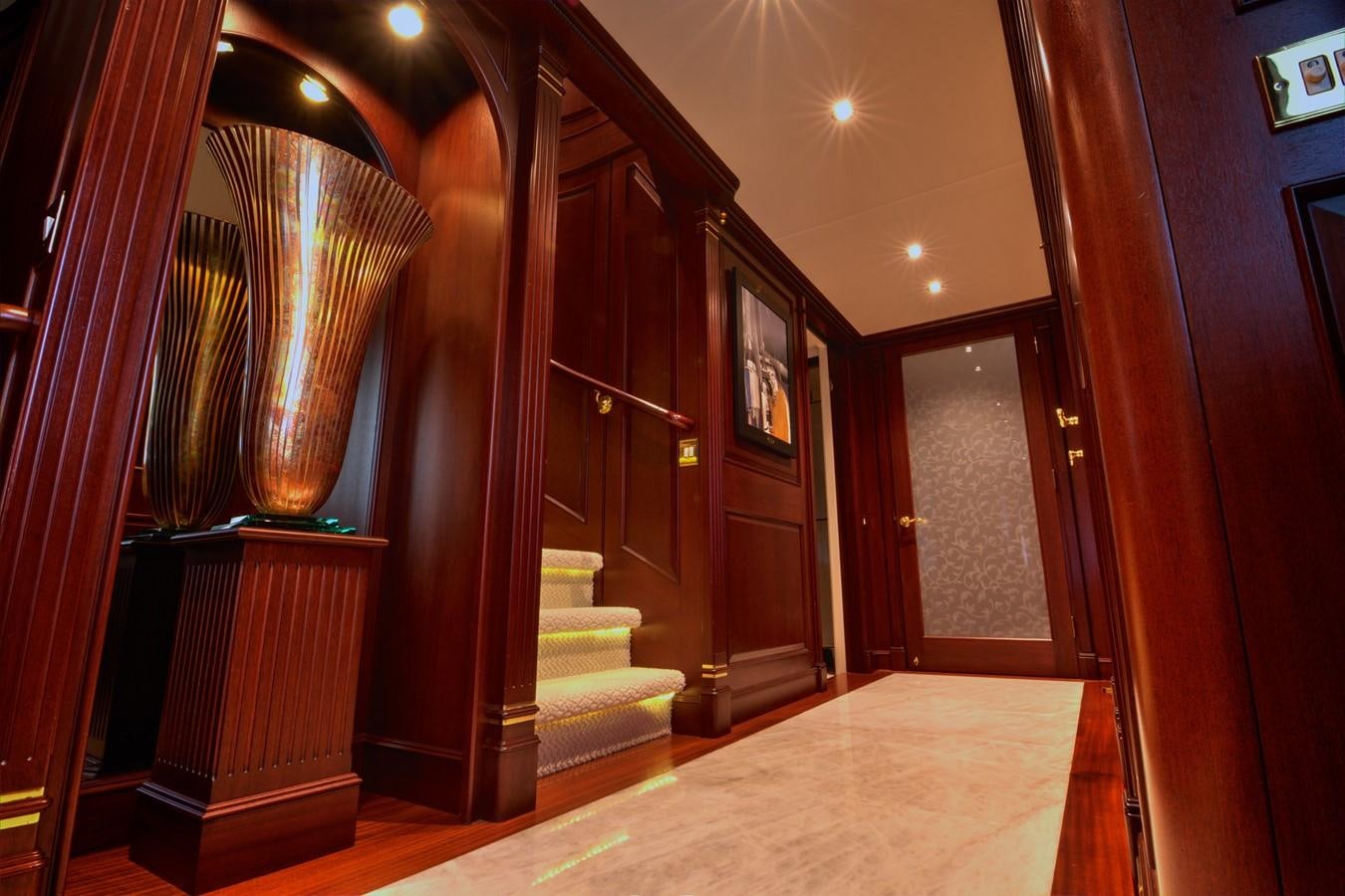 a hallway with a staircase and a glass door aboard SCORPIO Yacht for Sale