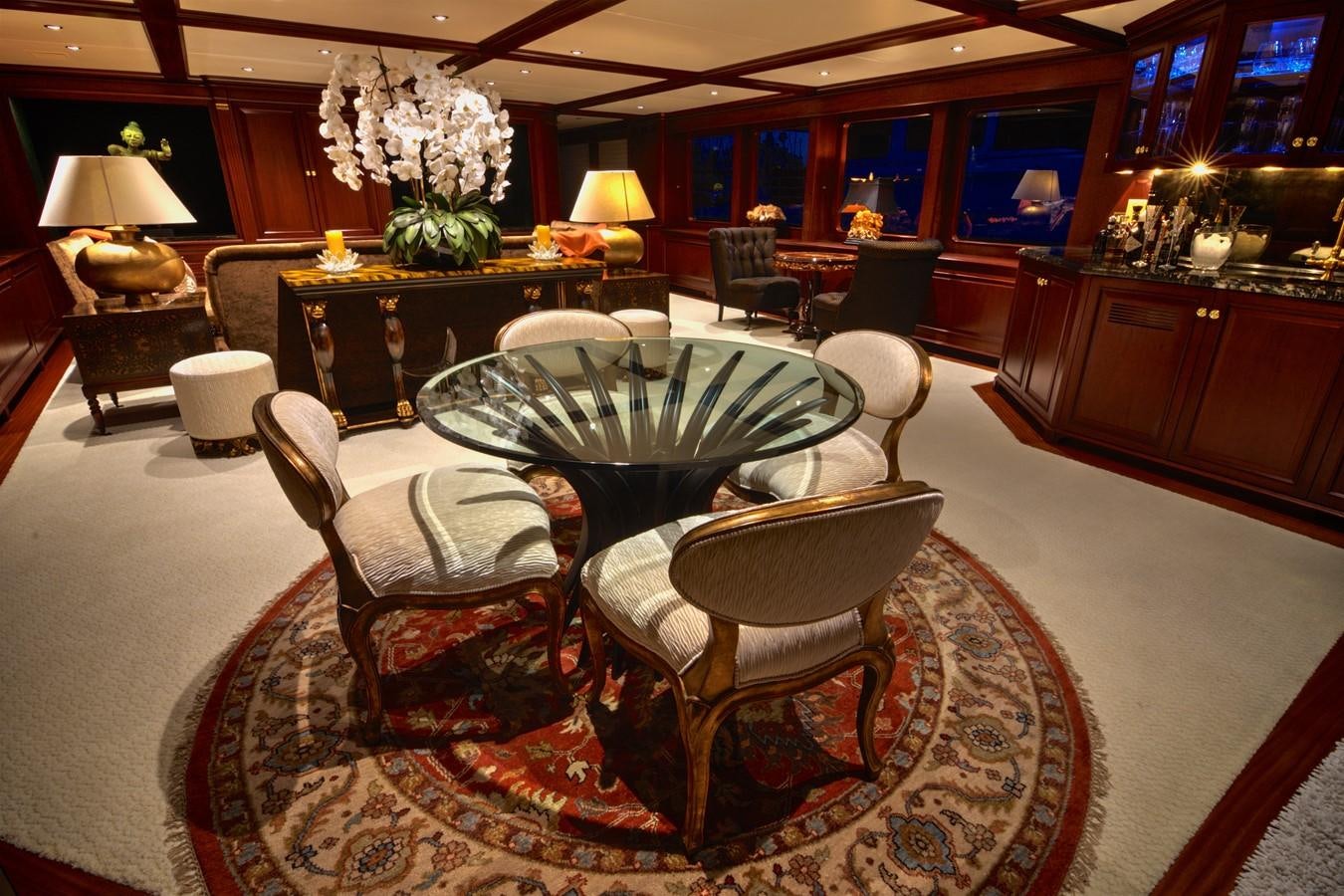 a fancy dining room with a chandelier aboard SCORPIO Yacht for Sale