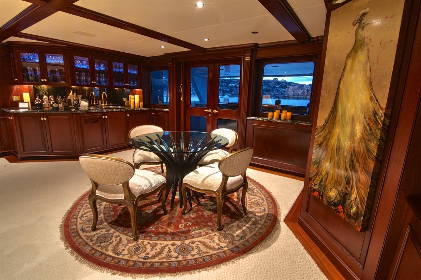 a room with a table and chairs aboard SCORPIO Yacht for Sale