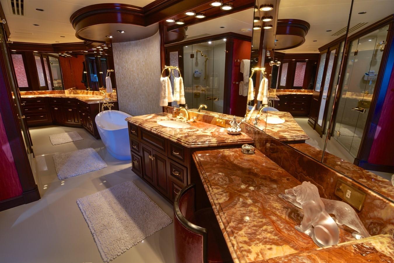 a large bathroom with a countertop sink and a large mirror aboard SCORPIO Yacht for Sale