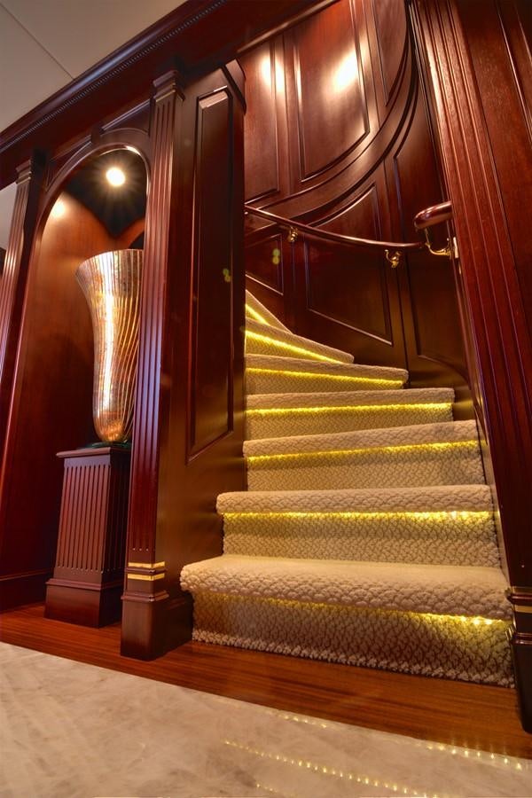 a staircase with a spiral staircase aboard SCORPIO Yacht for Sale