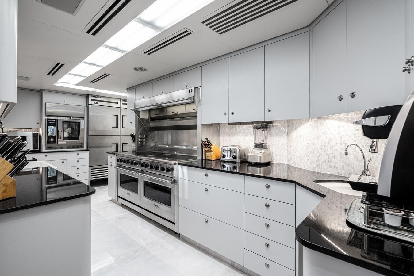a kitchen with white cabinets aboard SCORPIO Yacht for Sale