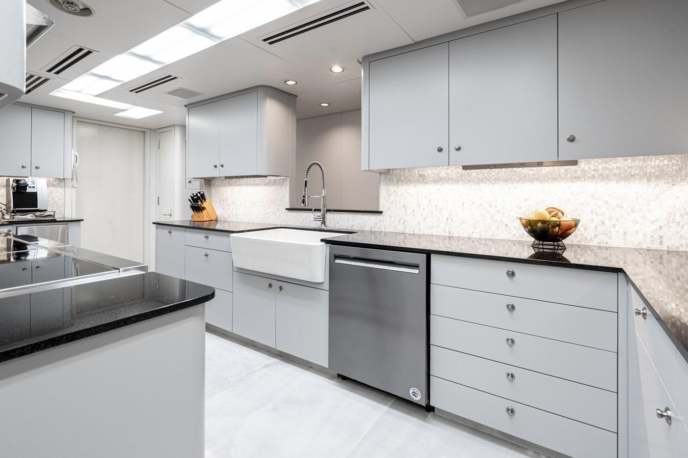 a kitchen with white cabinets aboard SCORPIO Yacht for Sale