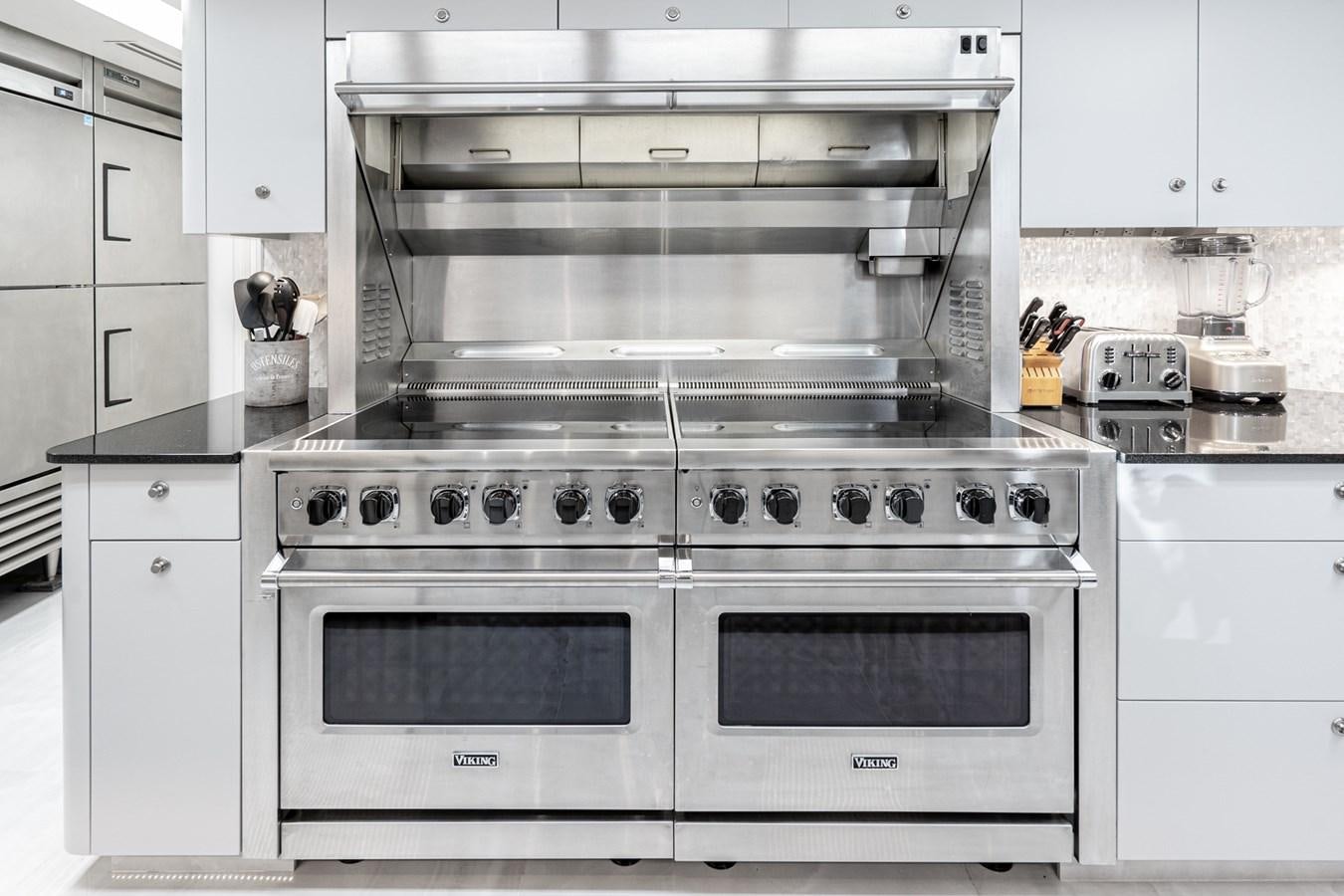 a kitchen with white cabinets aboard SCORPIO Yacht for Sale