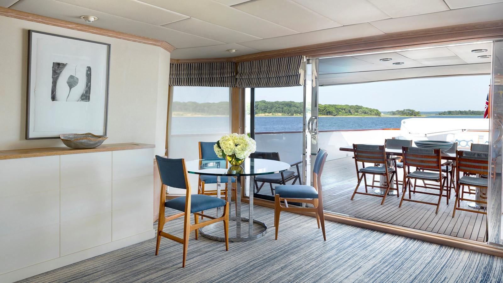 a dining room with a table and chairs aboard NATALIA V Yacht for Sale