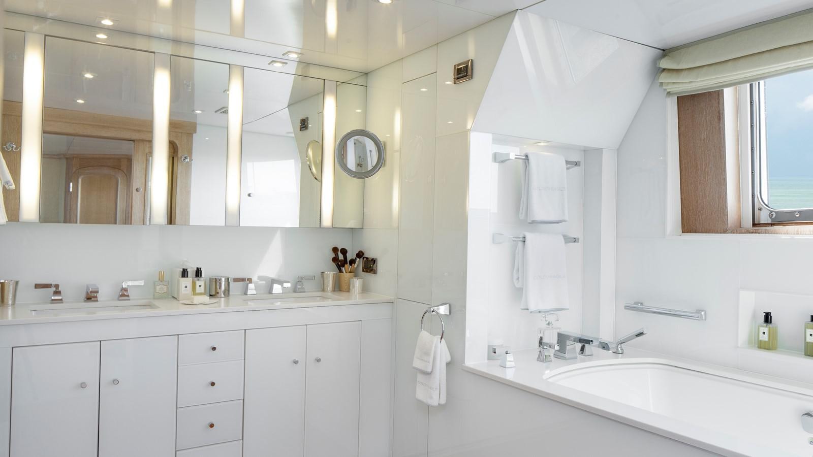 a bathroom with white cabinets aboard NATALIA V Yacht for Sale