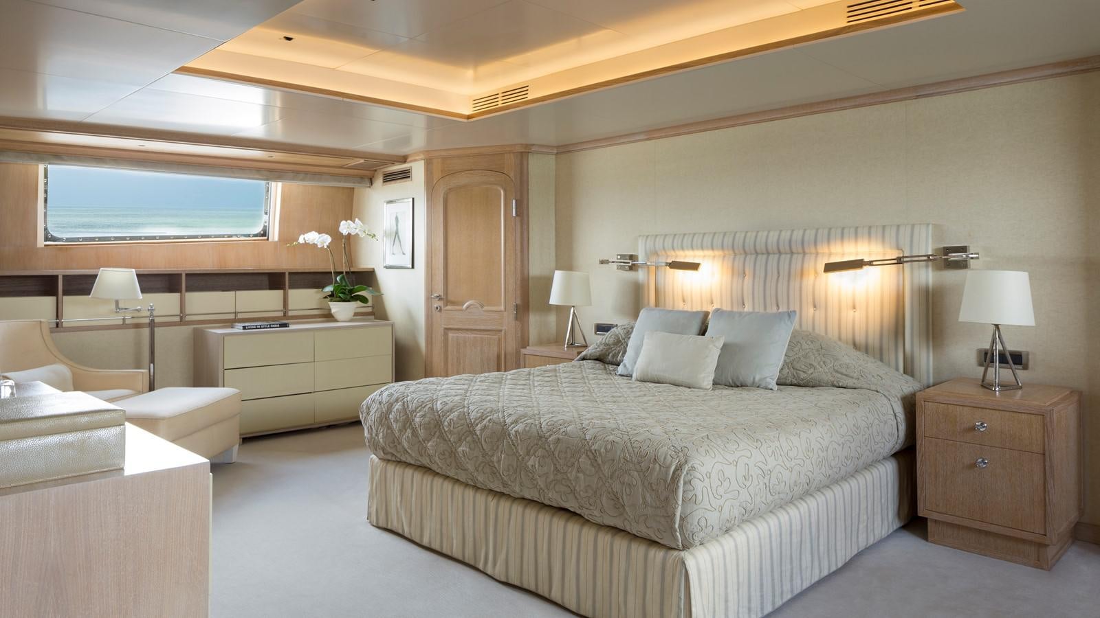 a large bedroom with a bed and a desk aboard NATALIA V Yacht for Sale
