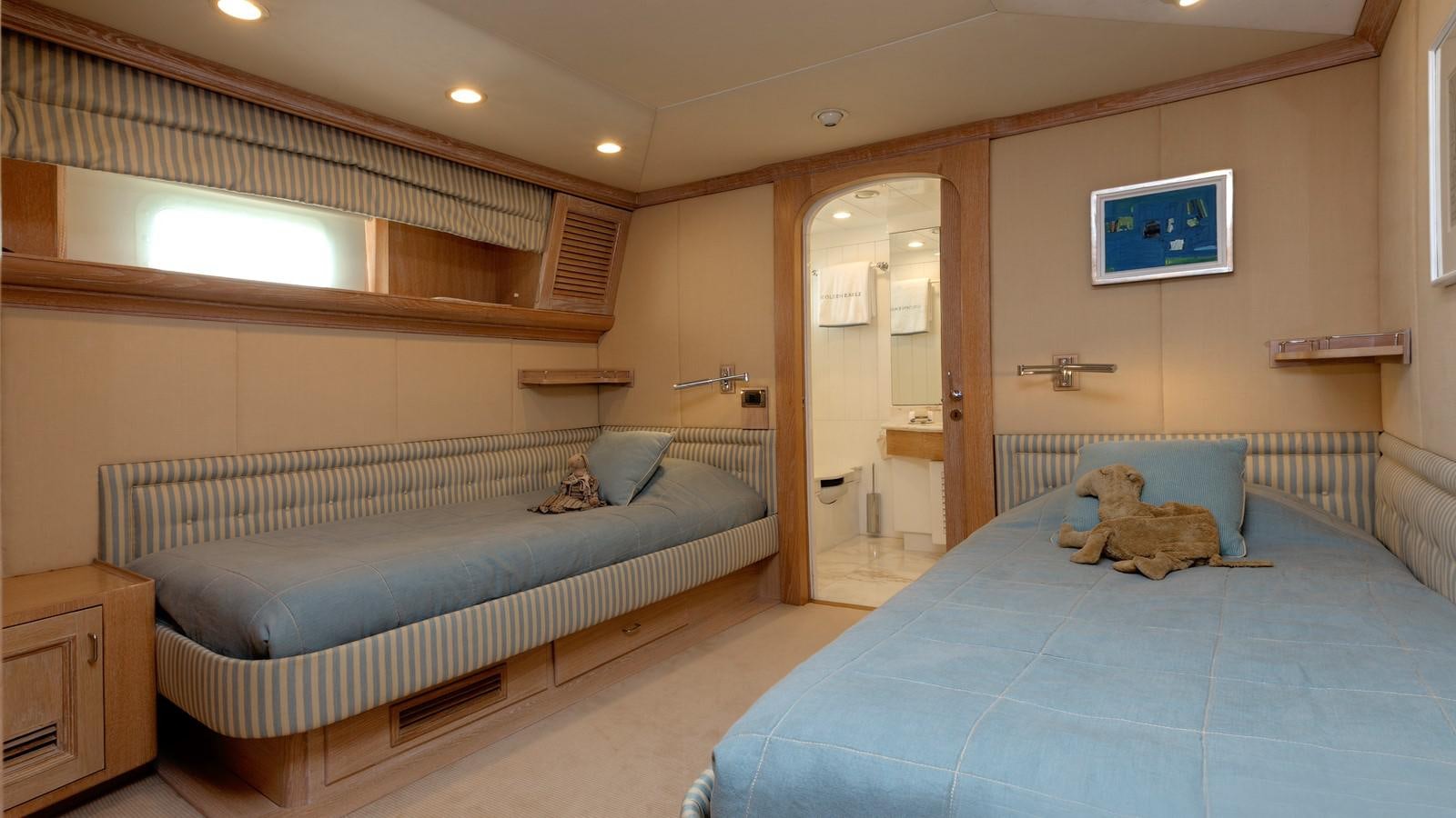 a bedroom with a bed and a television on the wall aboard NATALIA V Yacht for Sale