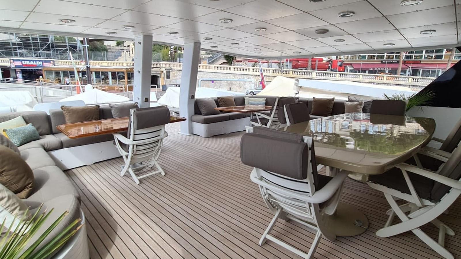 a room with a table and chairs aboard COSTA MAGNA Yacht for Charter