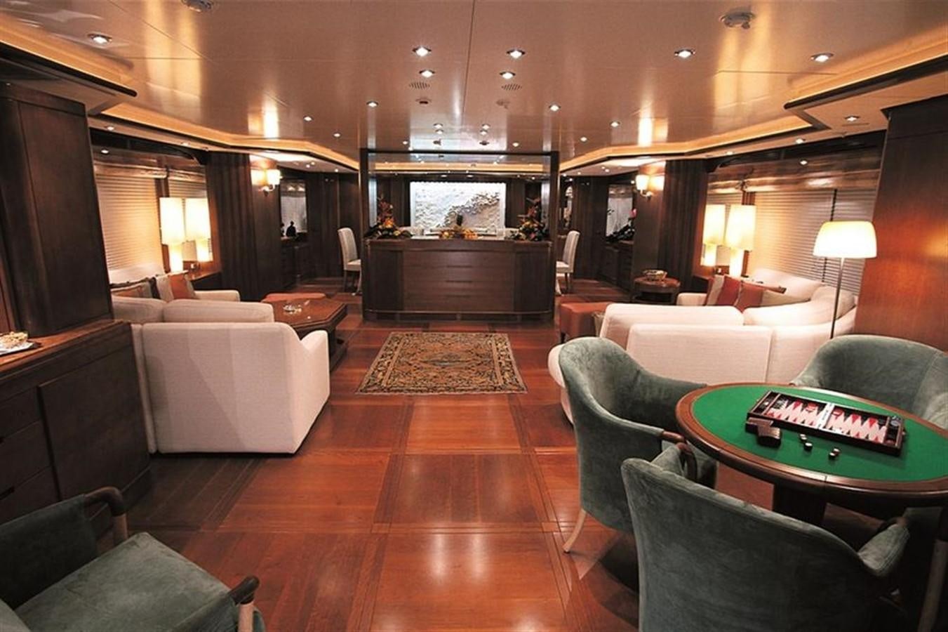 a living room with a fireplace aboard MORE Yacht for Sale