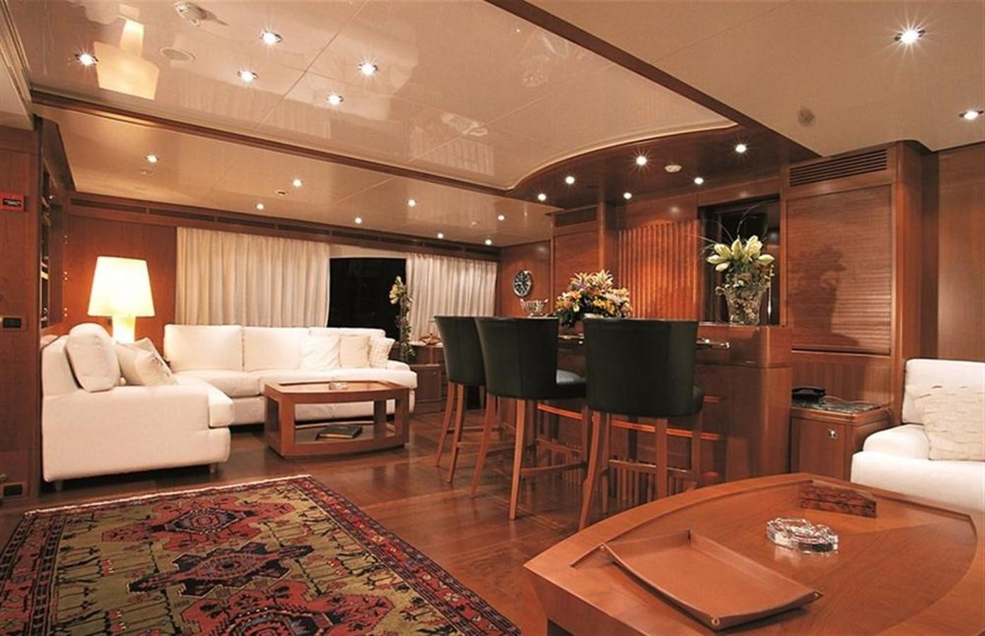 a living room with a pool table and chairs aboard MORE Yacht for Sale