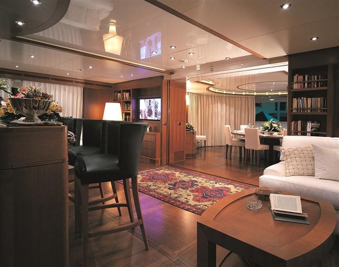 a living room with a table and chairs aboard MORE Yacht for Sale