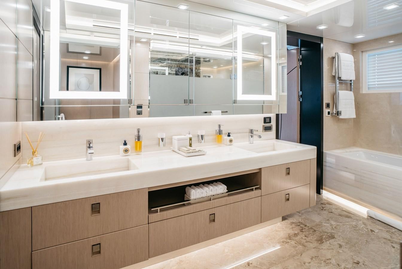 a bathroom with a large mirror aboard BERING B145 #02 Yacht for Sale
