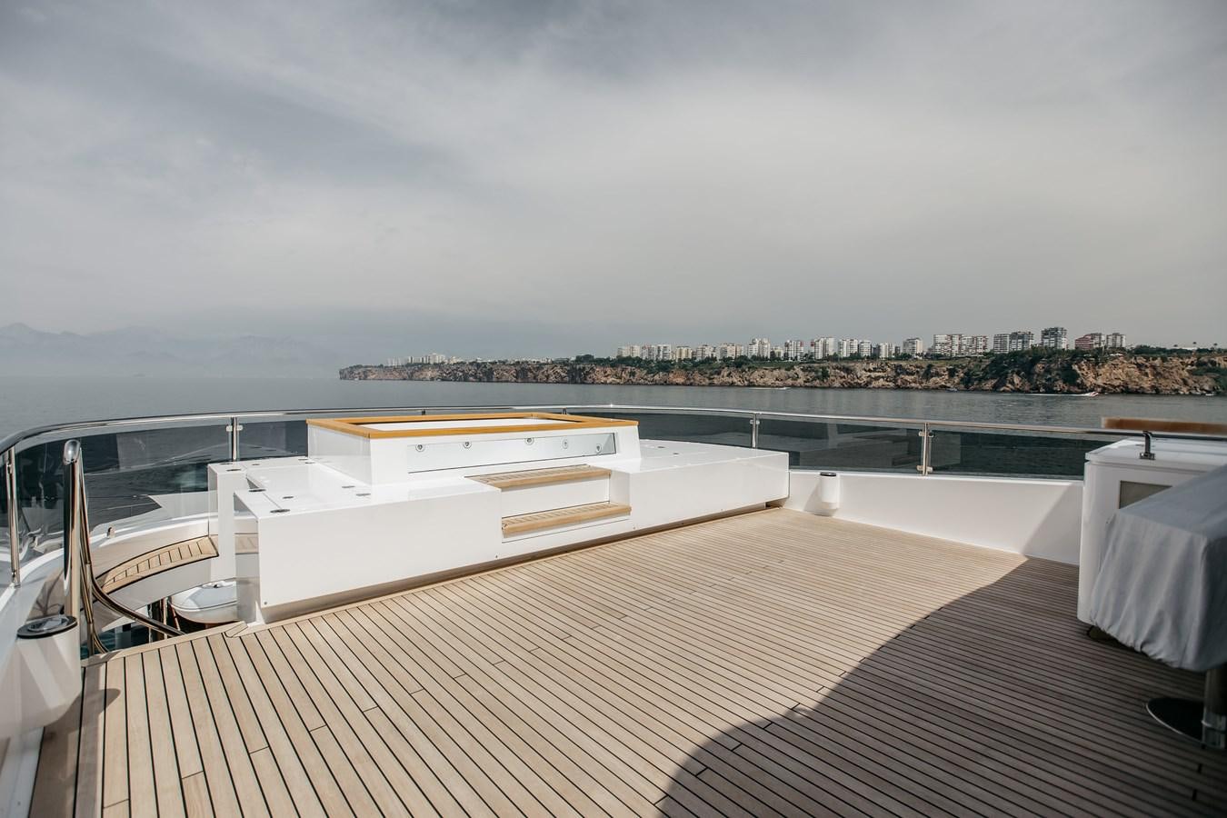 a deck with a view of a city and a body of water aboard BERING B145 #02 Yacht for Sale