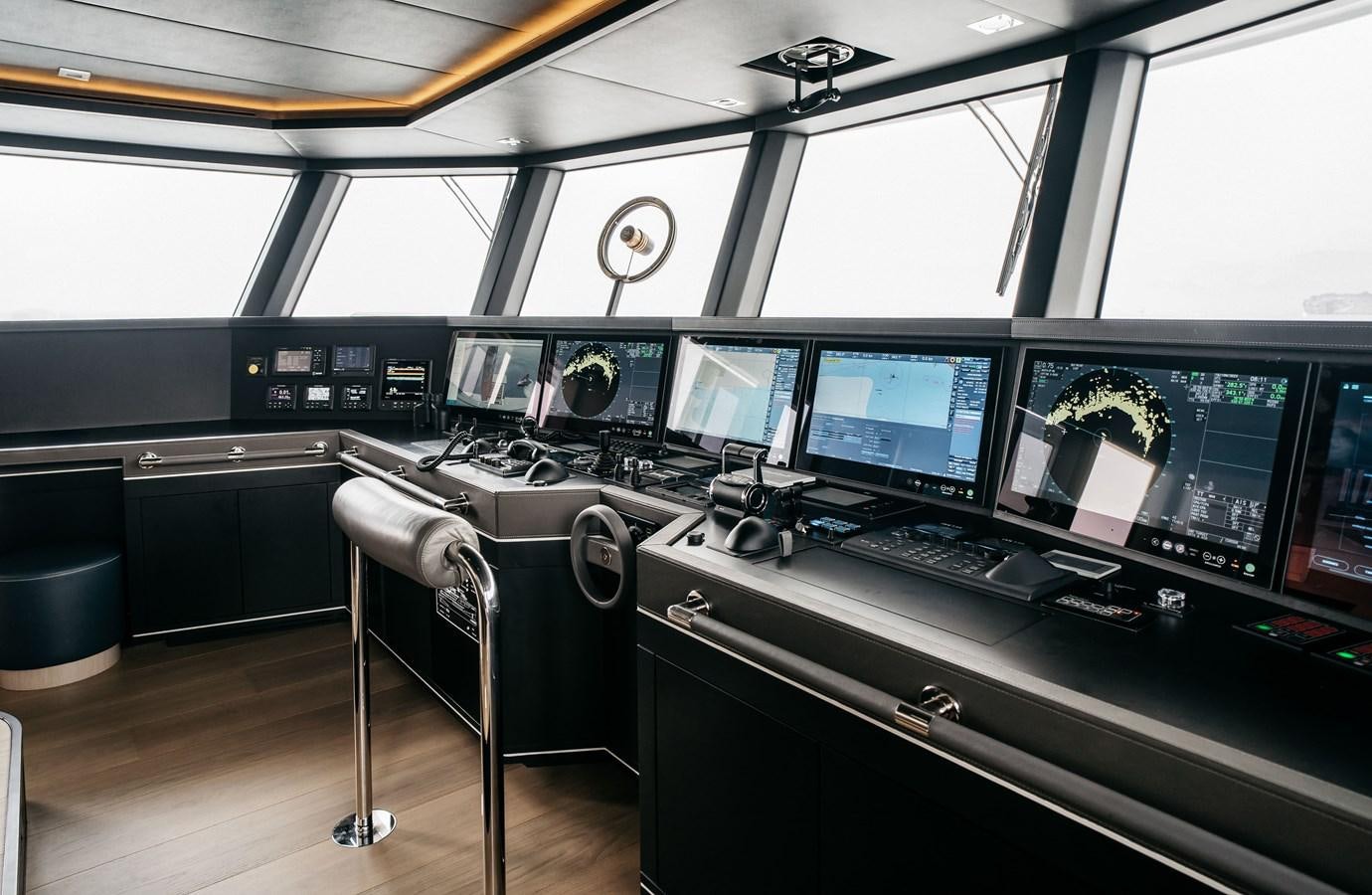 a control room with many monitors aboard BERING B145 #02 Yacht for Sale