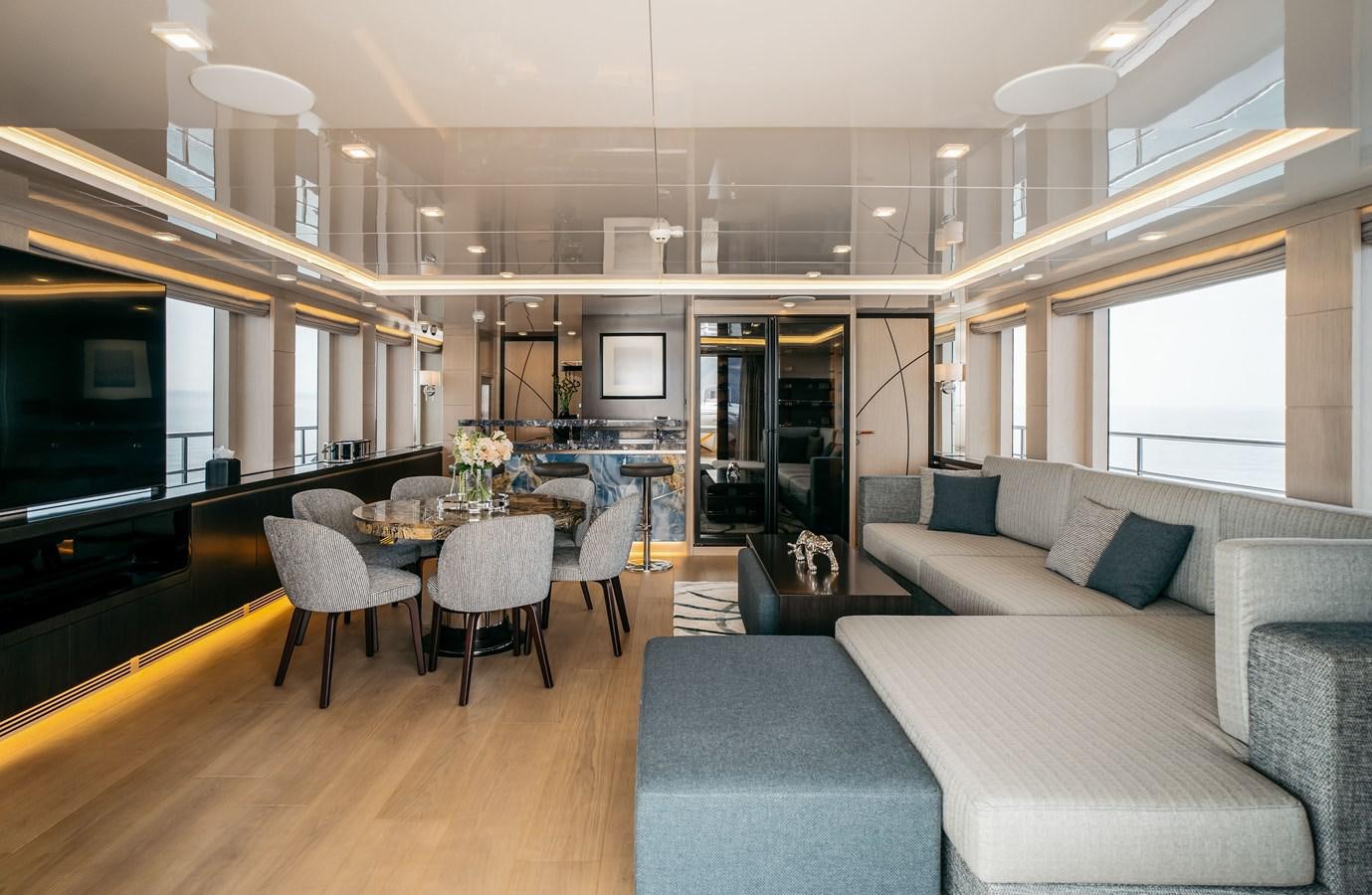a living room with a table and couches aboard BERING B145 #02 Yacht for Sale