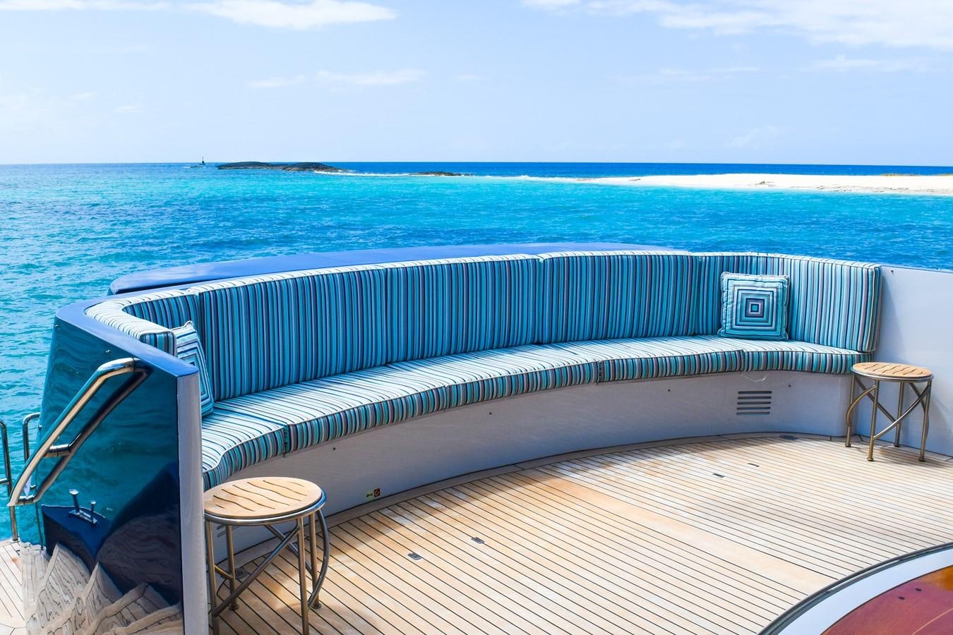 a bed on a deck overlooking the ocean aboard OCTOPUSSY Yacht for Sale