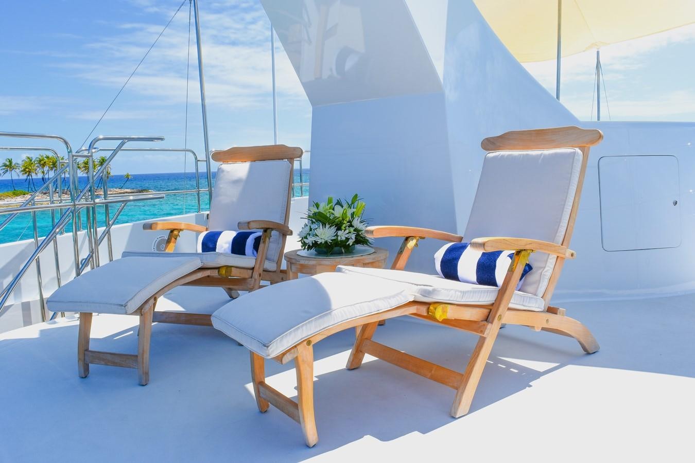 a group of chairs on a deck aboard OCTOPUSSY Yacht for Sale