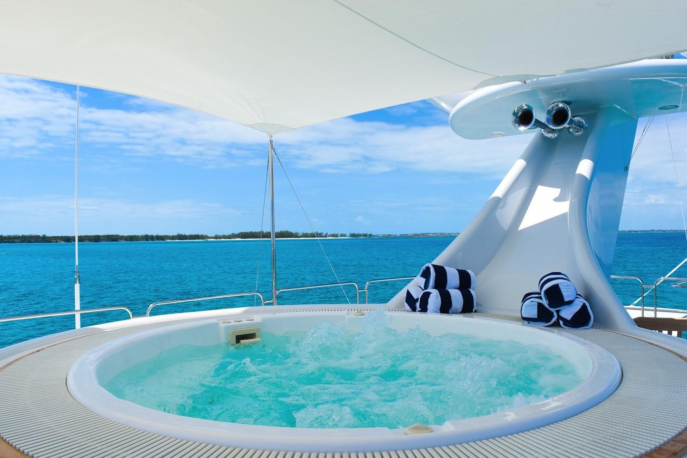 a white boat with a dolphin head aboard OCTOPUSSY Yacht for Sale