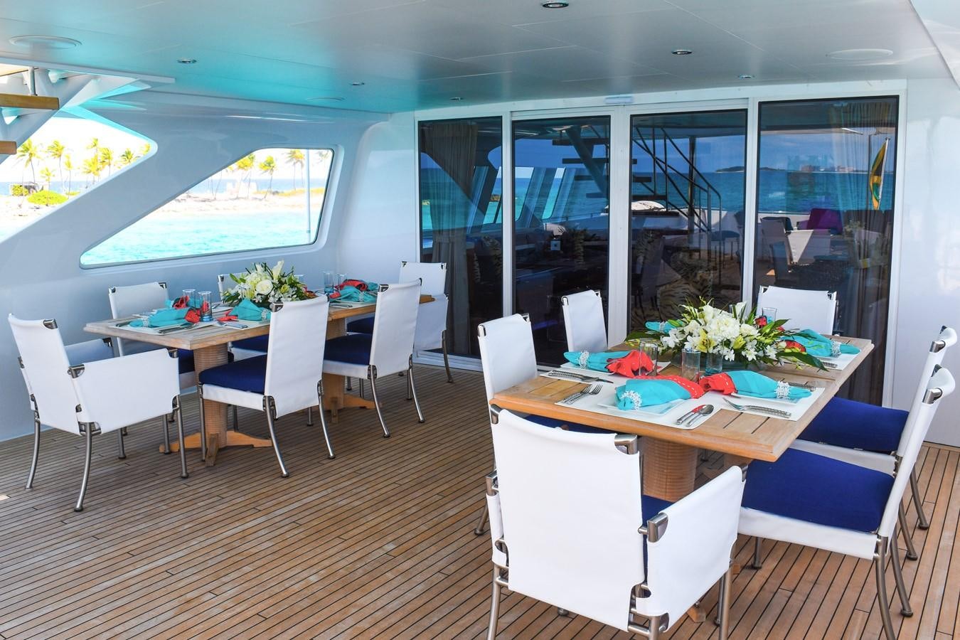 a room with tables and chairs aboard OCTOPUSSY Yacht for Sale