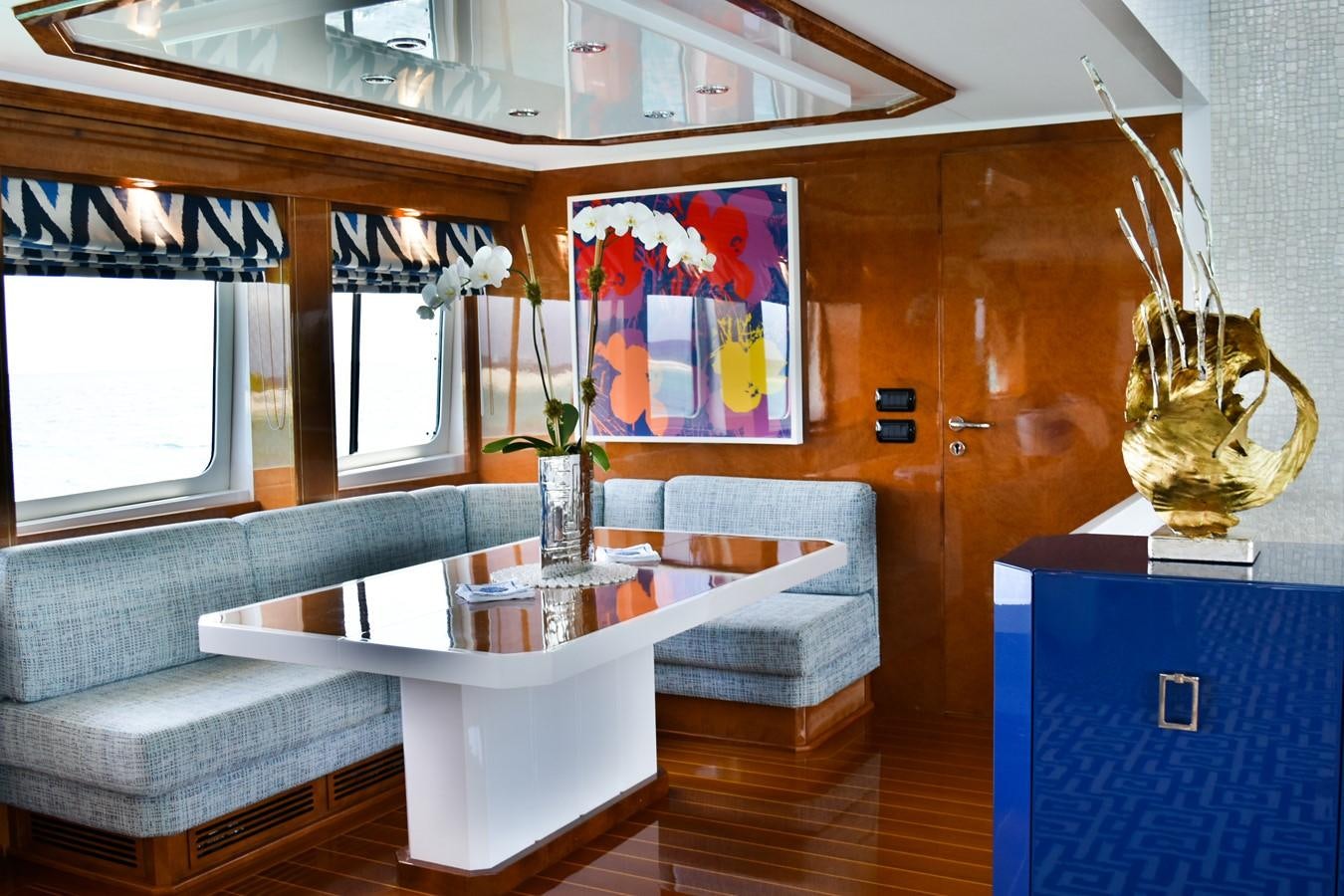 a room with a table and couch aboard OCTOPUSSY Yacht for Sale