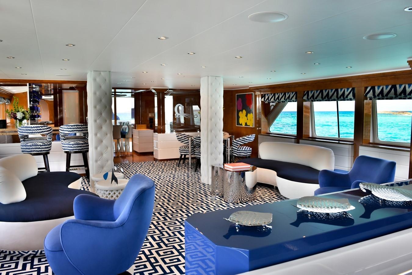 a large room with a pool table and chairs aboard OCTOPUSSY Yacht for Sale