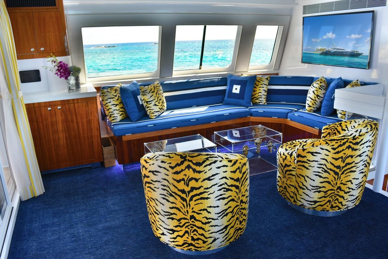 a living room with a blue couch aboard OCTOPUSSY Yacht for Sale