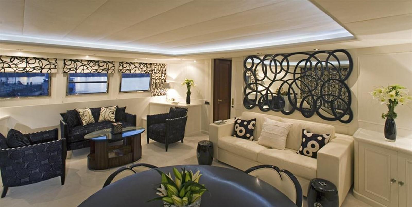 a living room with a couch and a table aboard SEA DREAM Yacht for Sale