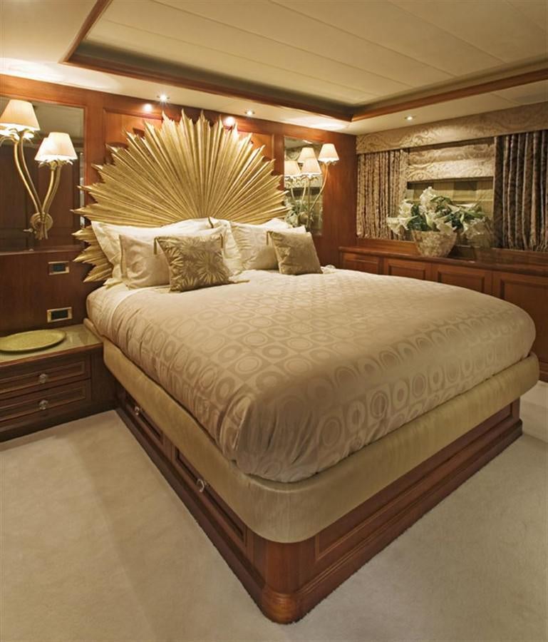 a bed with a large headboard aboard SEA DREAM Yacht for Sale