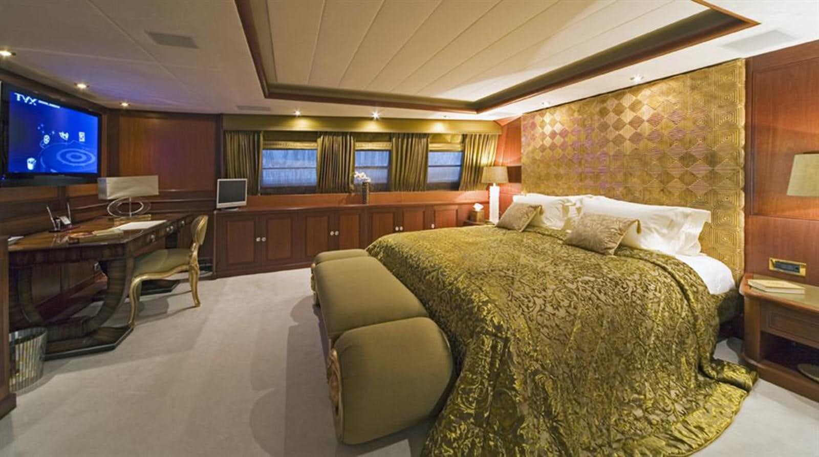 a hotel room with a bed and a desk aboard SEA DREAM Yacht for Sale