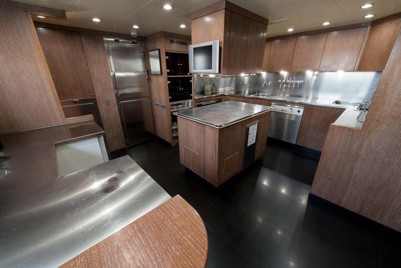 a kitchen with wooden cabinets aboard ELEMENT Yacht for Charter