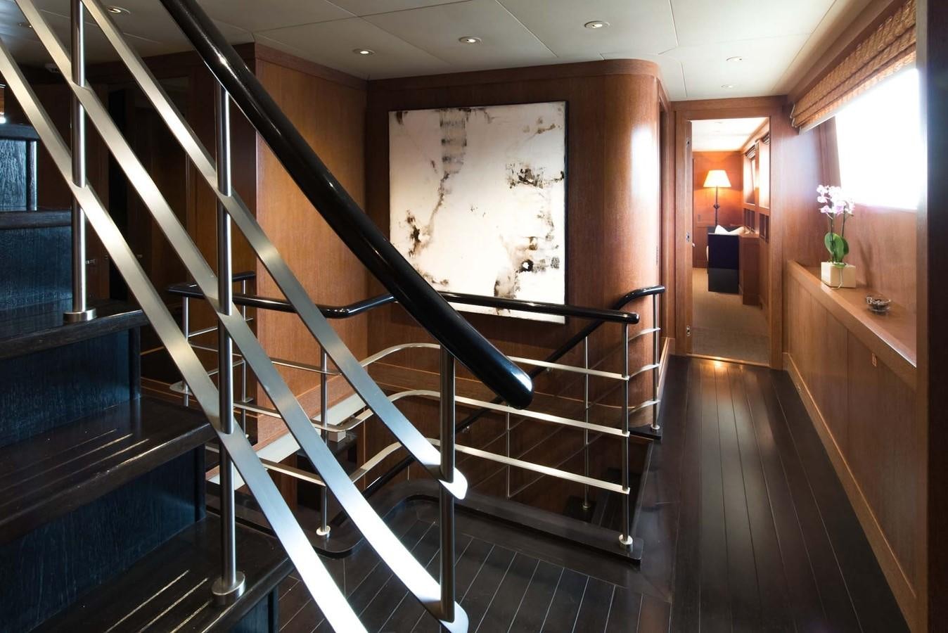 a staircase with a painting on the wall aboard ELEMENT Yacht for Charter