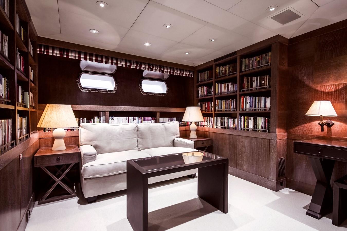 a living room with a couch and a book shelf aboard ELEMENT Yacht for Charter
