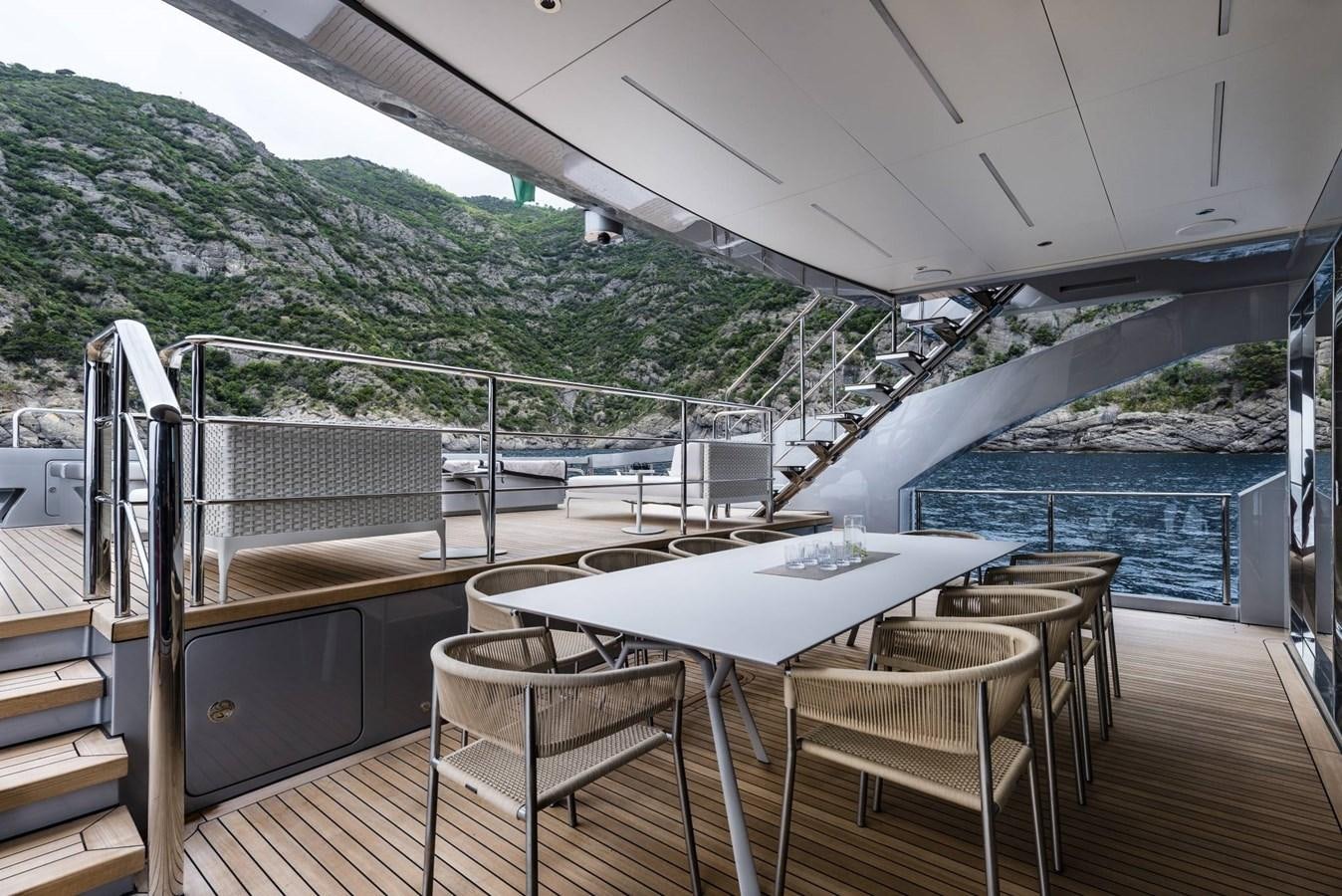 a table and chairs on a deck aboard TOUCH ME Yacht for Sale