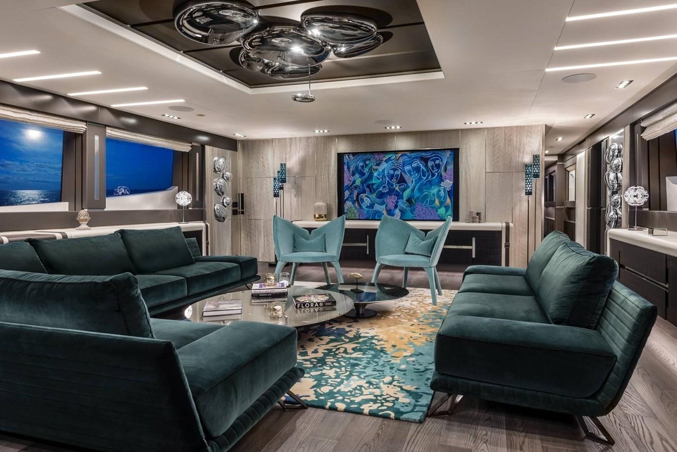 a living room with blue chairs aboard TOUCH ME Yacht for Sale