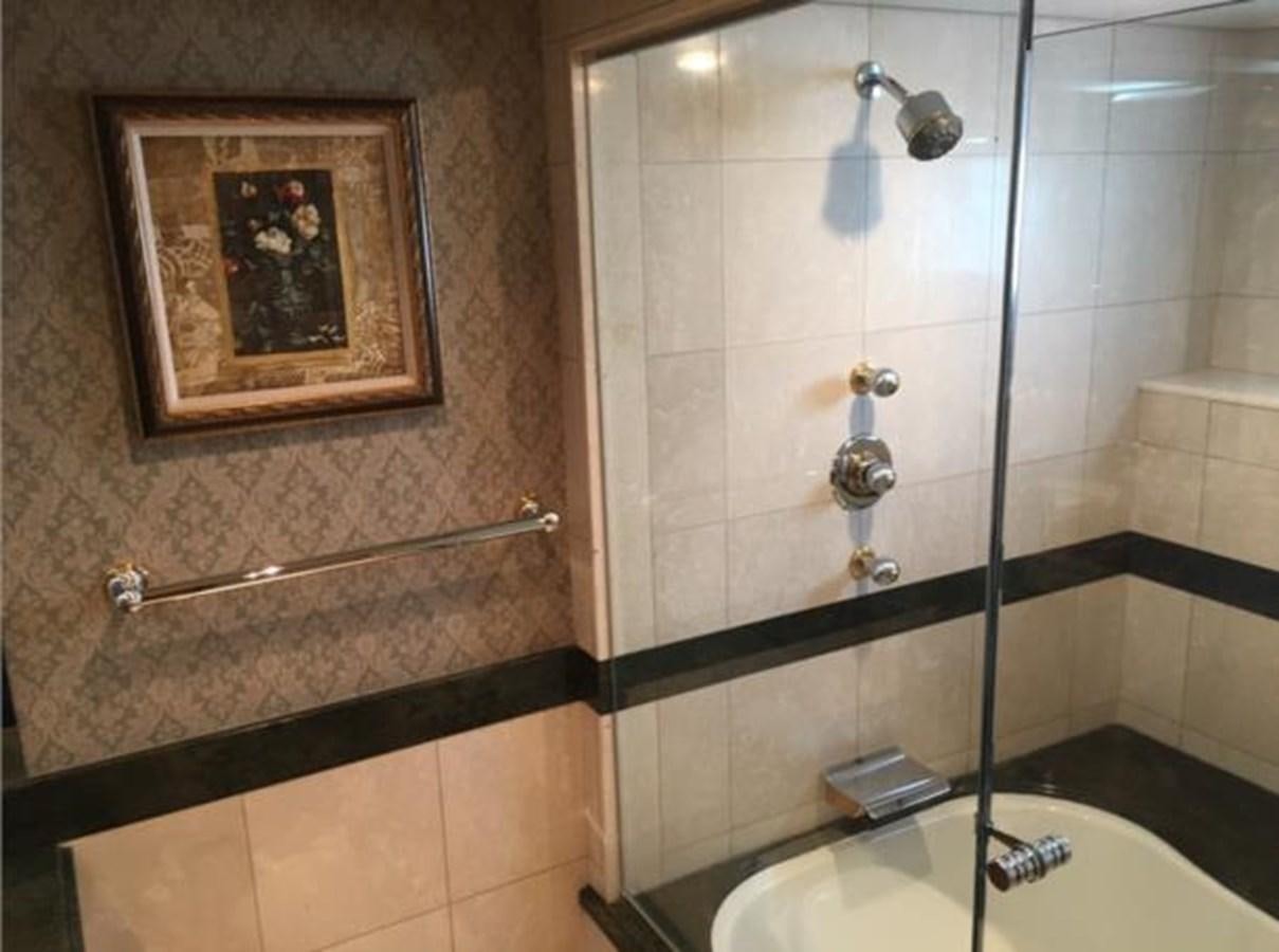 a bathroom with a picture on the wall aboard MCY Yacht for Sale