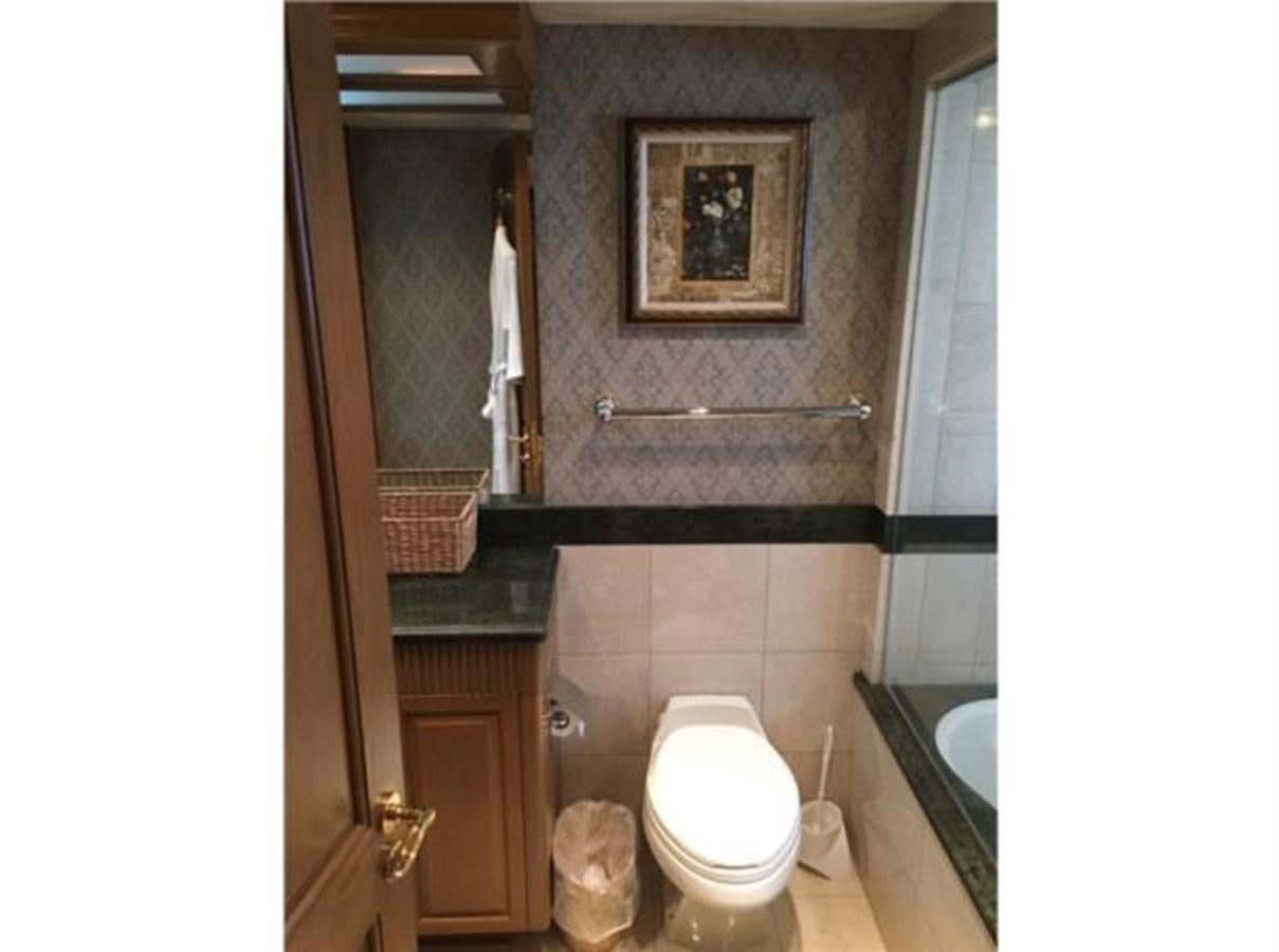 a bathroom with a toilet and a sink aboard MCY Yacht for Sale