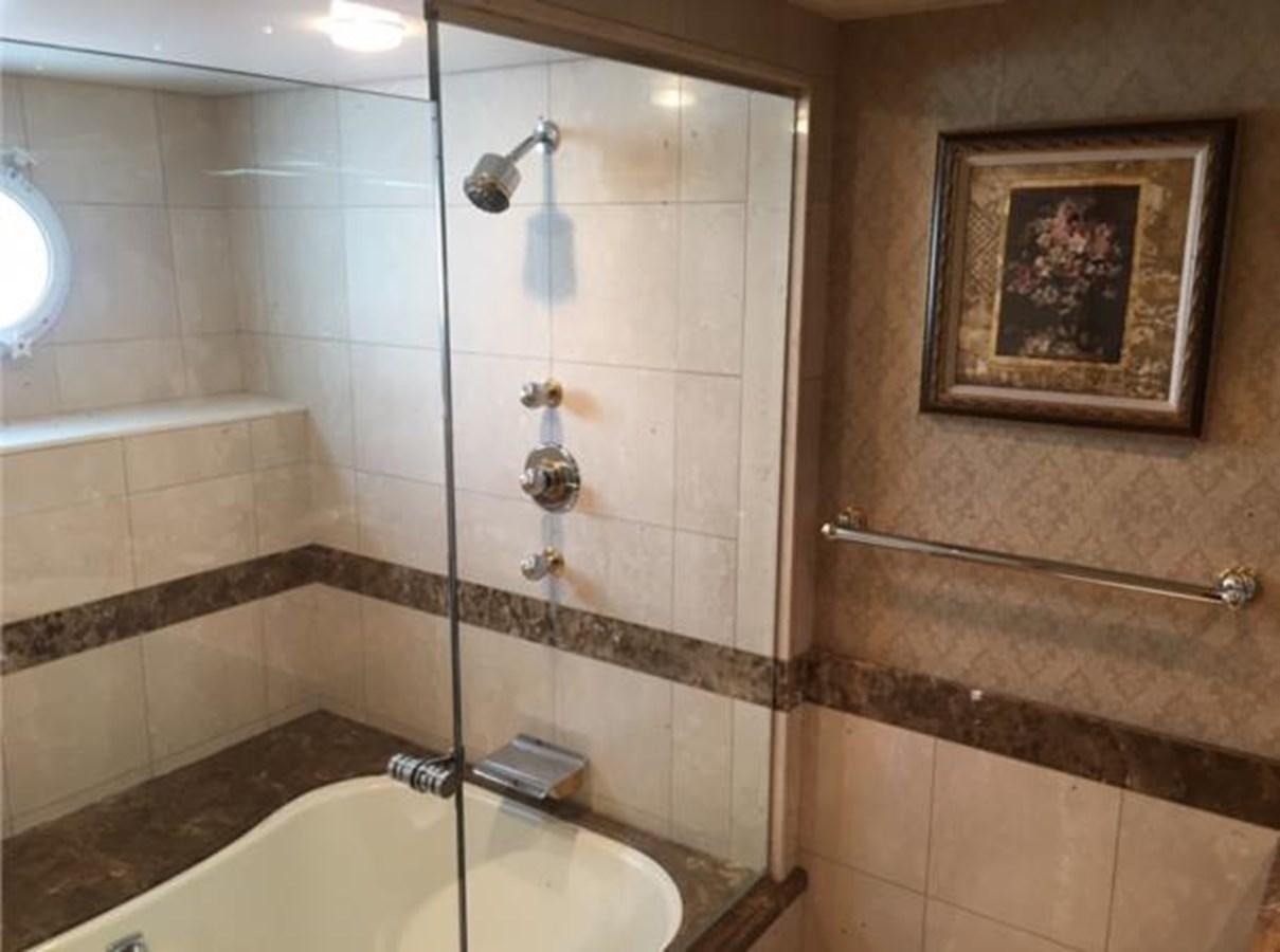 a bathroom with a picture on the wall aboard MCY Yacht for Sale